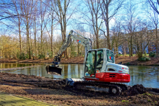 Photo of an excavator digging a pond